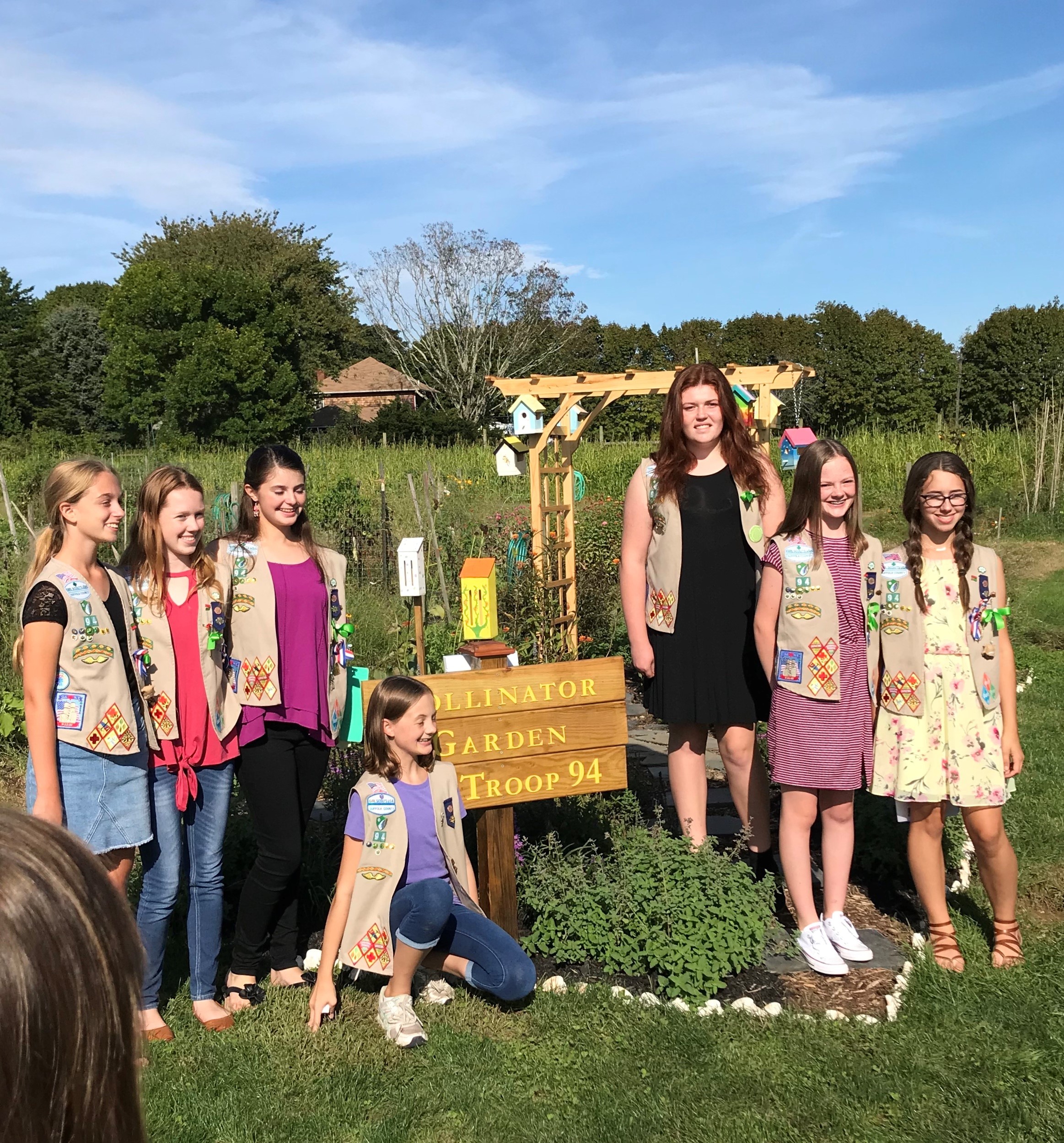 Girl Scouts in front of the Pollinator Garden
