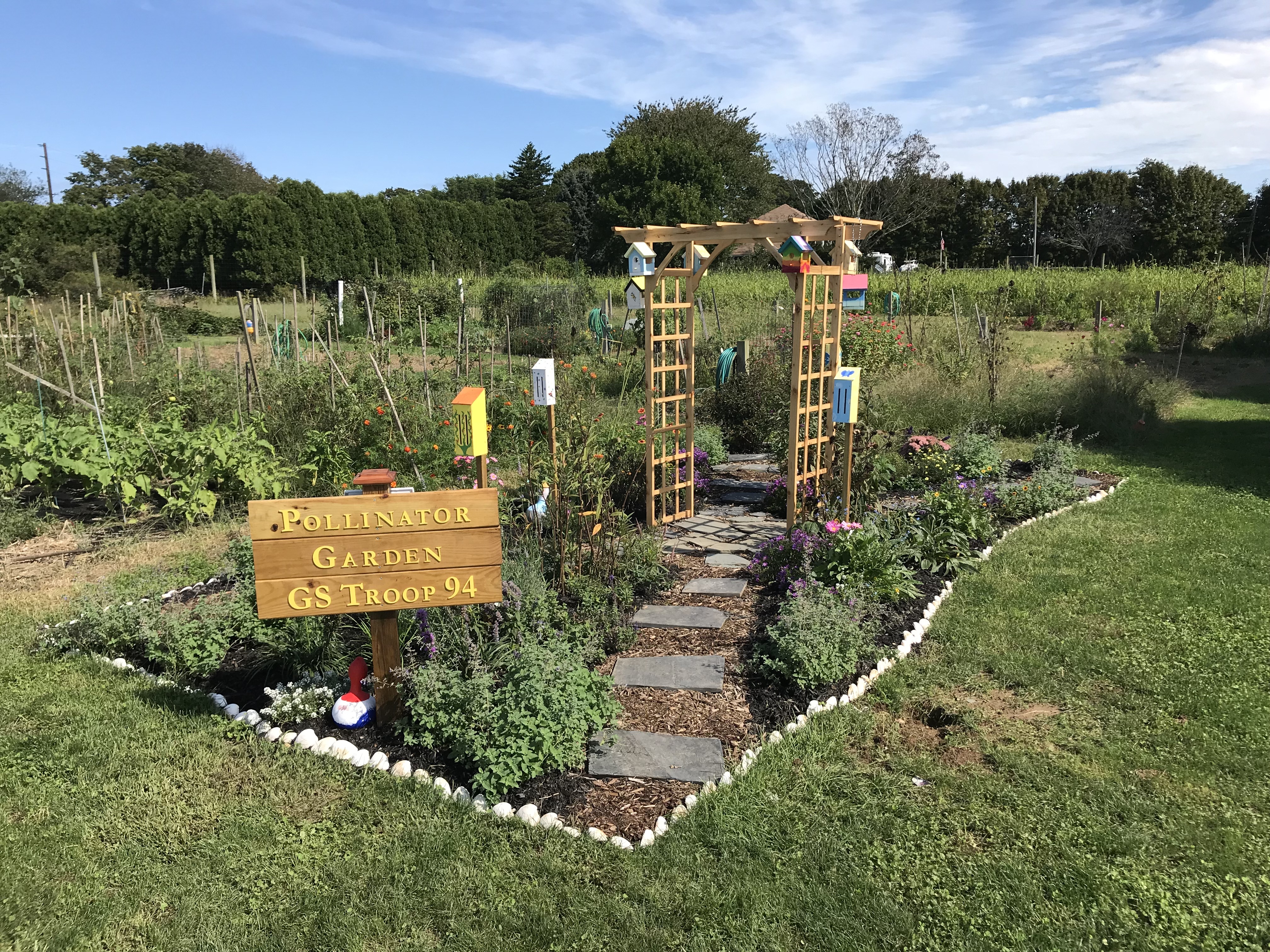 pollinator garden with sign and pathway