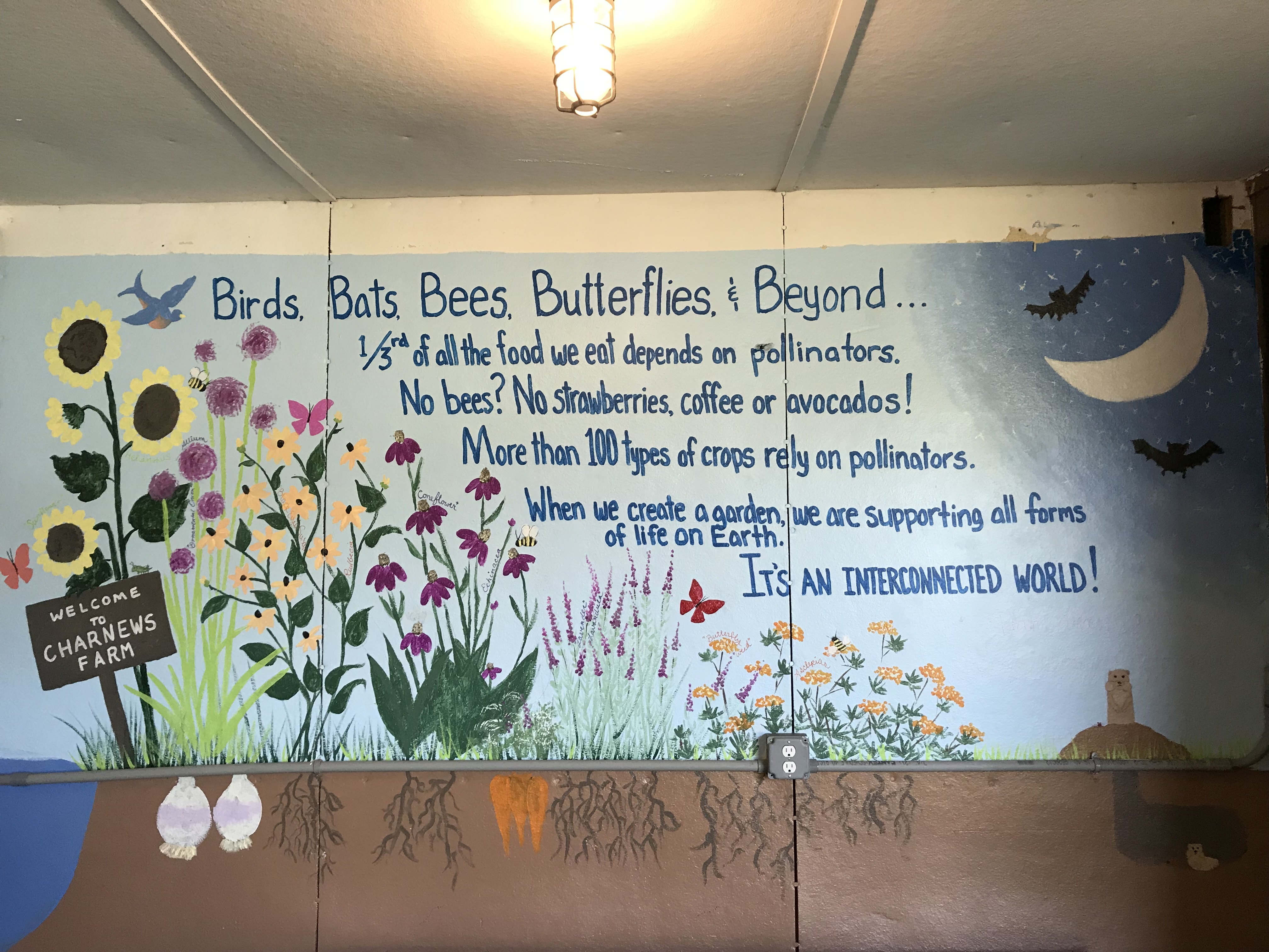 mural of pollinator flowers and a poem