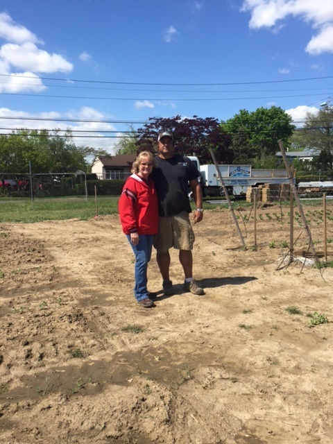 Two people standing on soil
