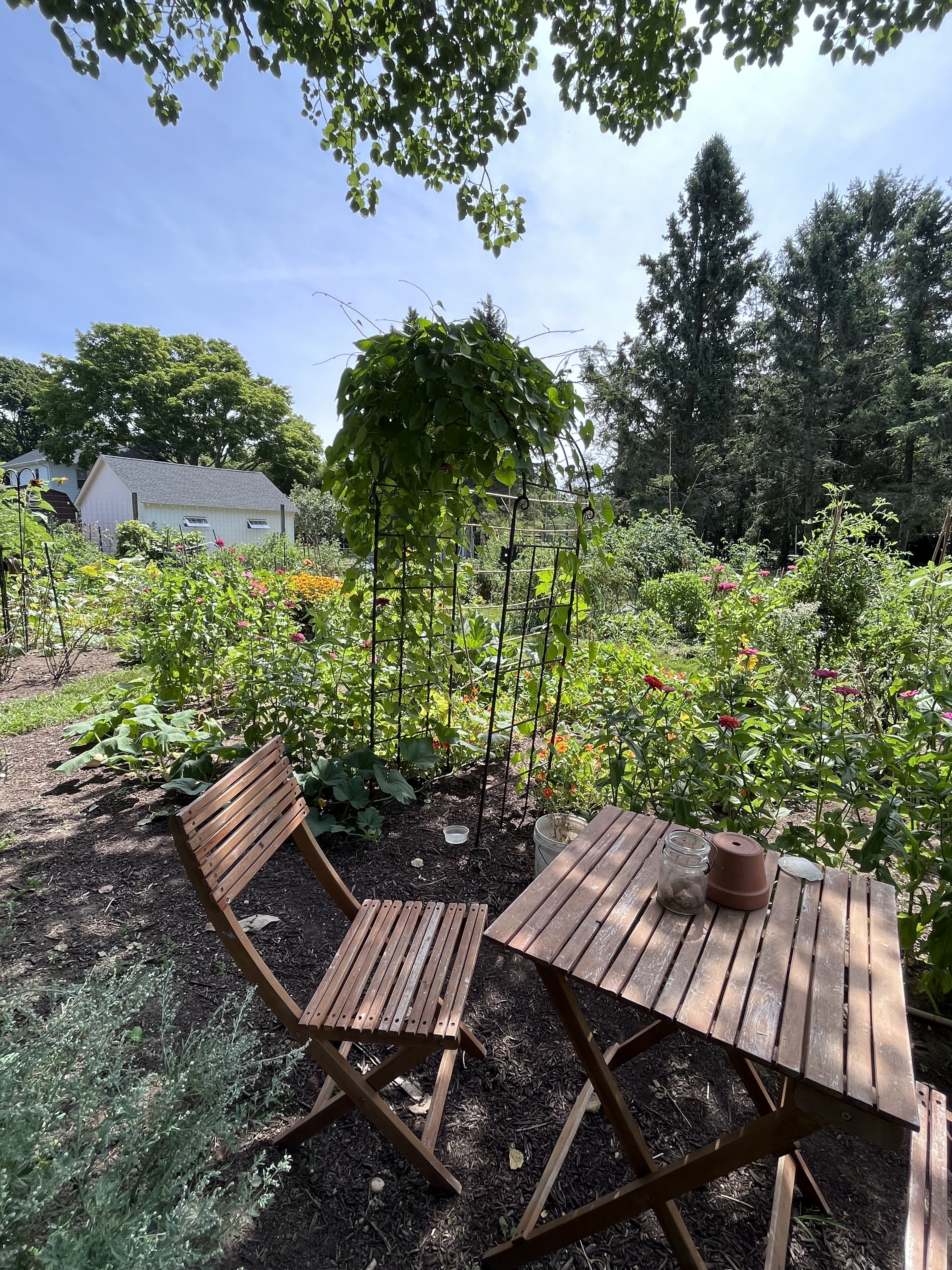 community garden plot with table and chair